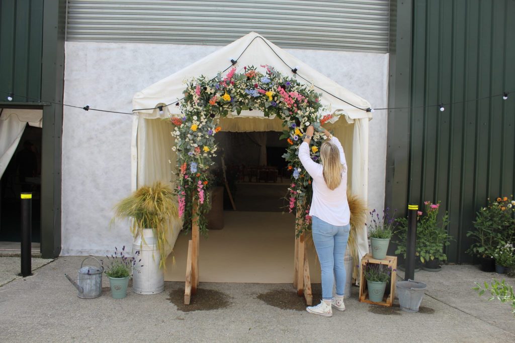 Megan Haigh - The Flowers of May finishing off a brightly coloured wild flower style floral archway